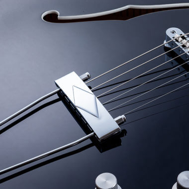 closeup of strong on black VOX electric guitar